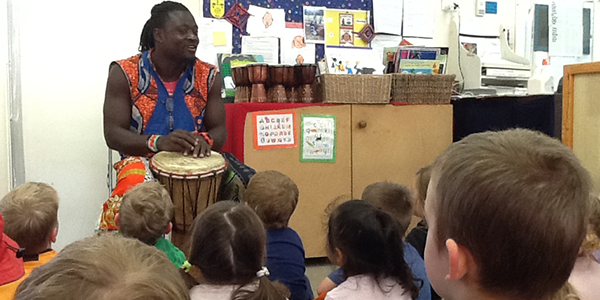 Kindergarten children being taught African drumming